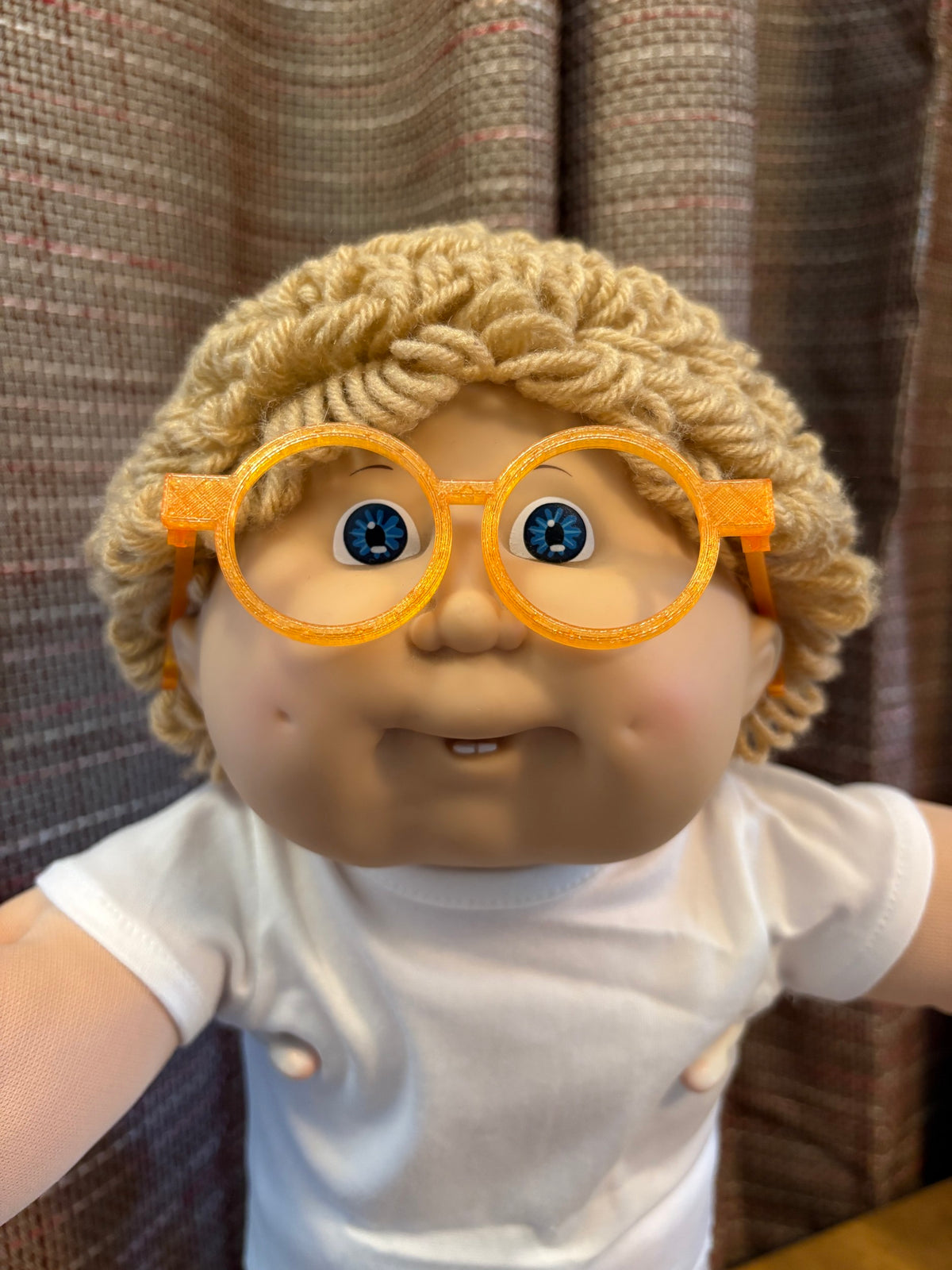 Orange round glasses on a 16 inch Cabbage Patch Kids doll