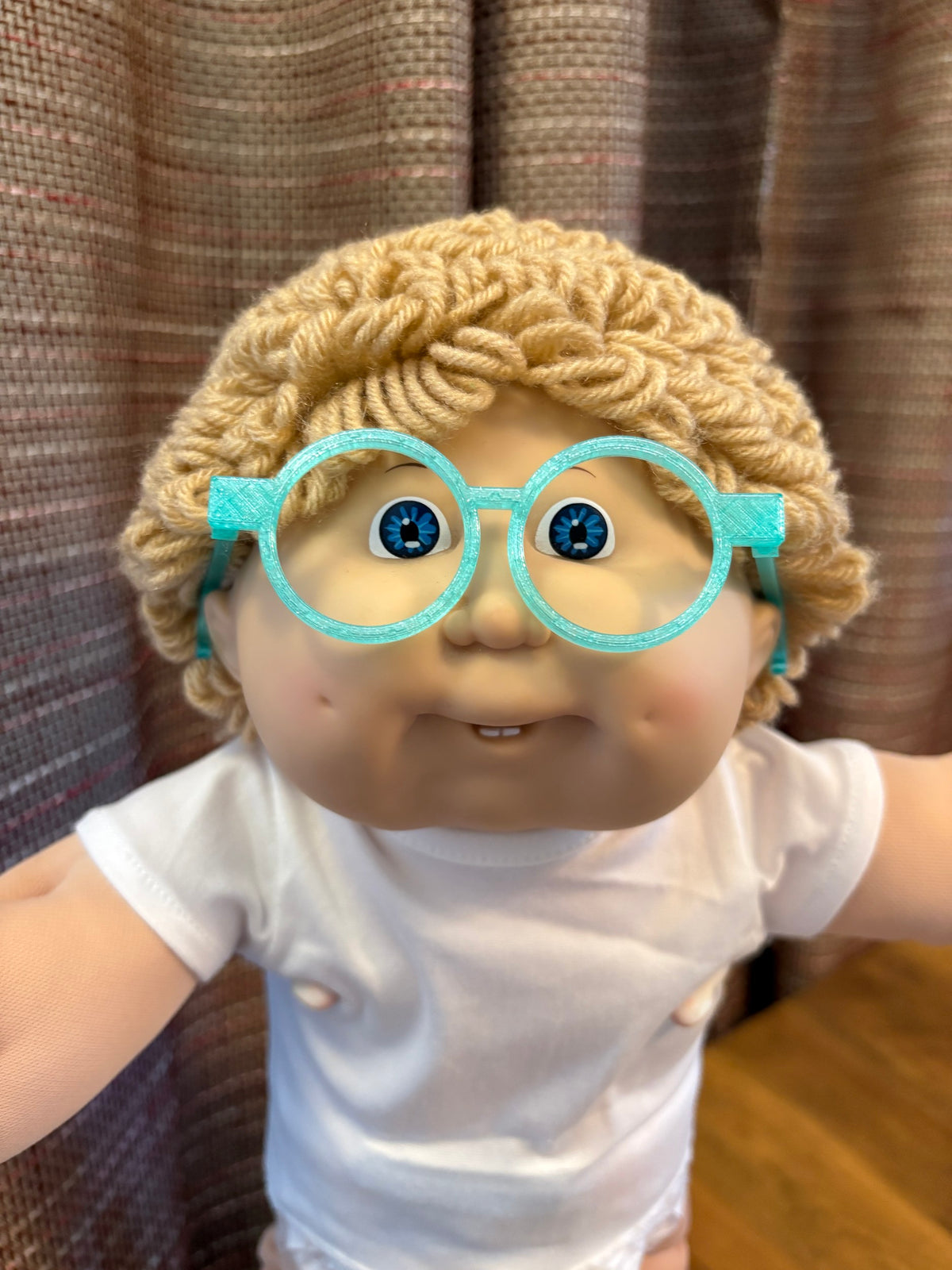 Teal round glasses on a 16 inch Cabbage Patch Kids doll
