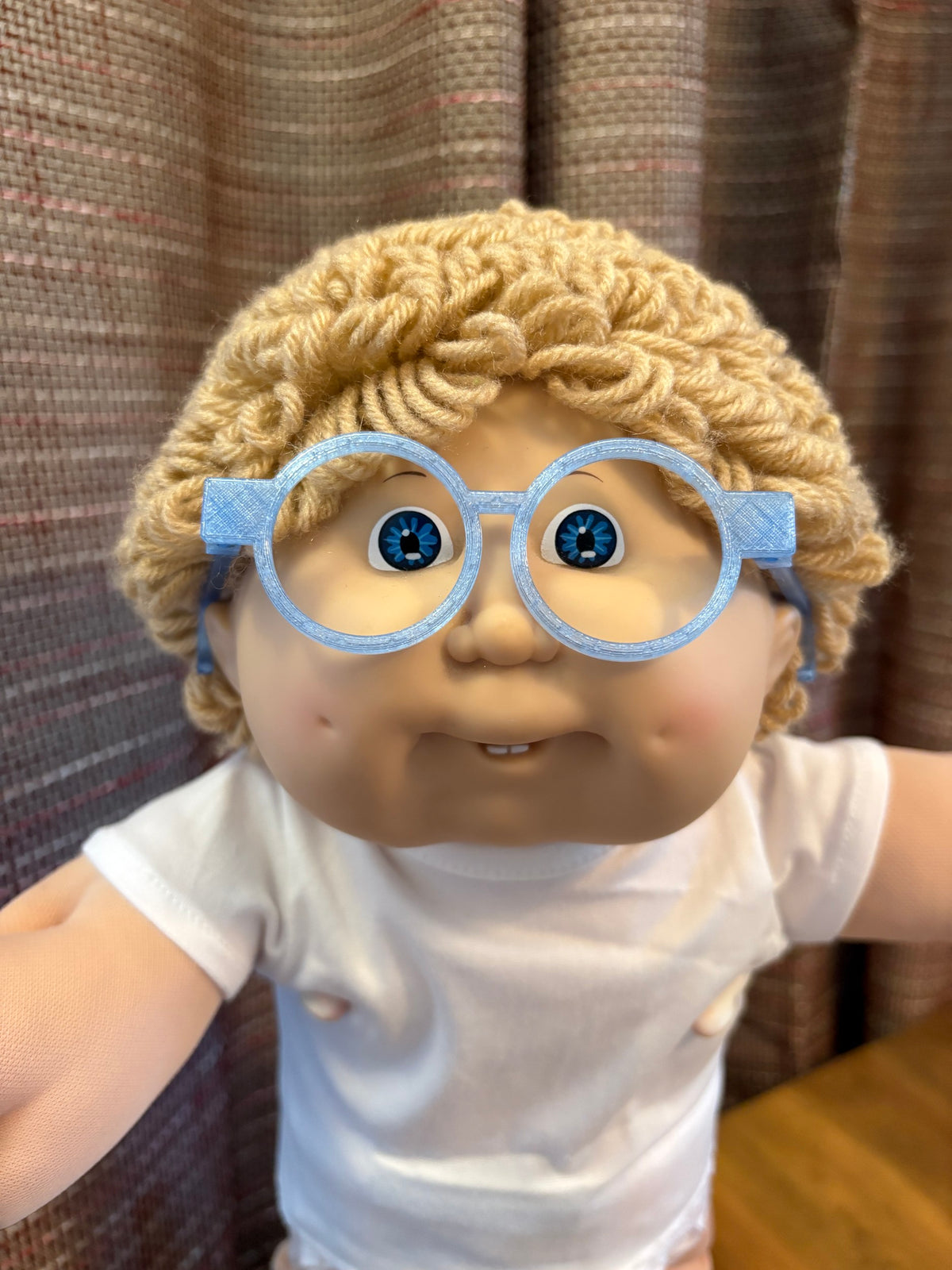 Blue round glasses on a 16 inch Cabbage Patch Kids doll